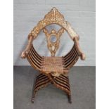 A late 19th century North African mother-of-pearl inlaid folding X-frame chair,