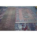 A machine made Caucasian style rug with a pink field, 230cm x 170cm,