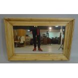 A modern pine rectangular wall mirror, 137cm wide x 91cm high.