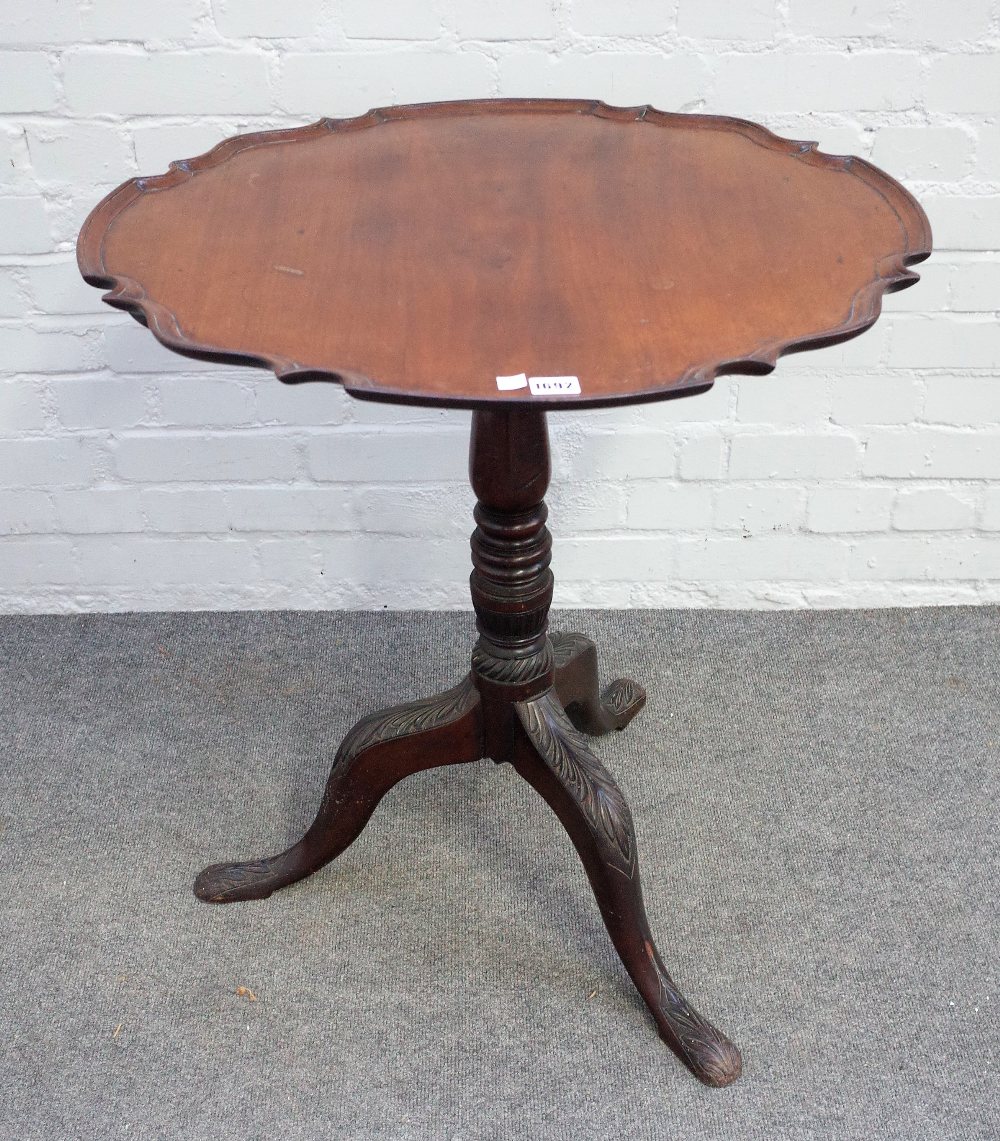 An 18th century Irish mahogany snap top piecrust occasional table on a tripod base,