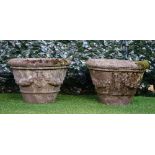 A pair of reconstituted stone circular jardinieres with floral swag decoration,