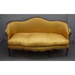 A Louis XV style tub back sofa, the shaped back over serpentine seat on eight shaped supports,
