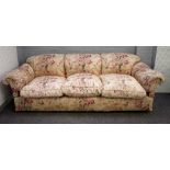 George Smith, a large triple hump back sofa in floral pattern upholstery, 250cm wide x 85cm high.