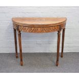 A late 19th century mahogany semi elliptic card table with carved frieze on tapering fluted