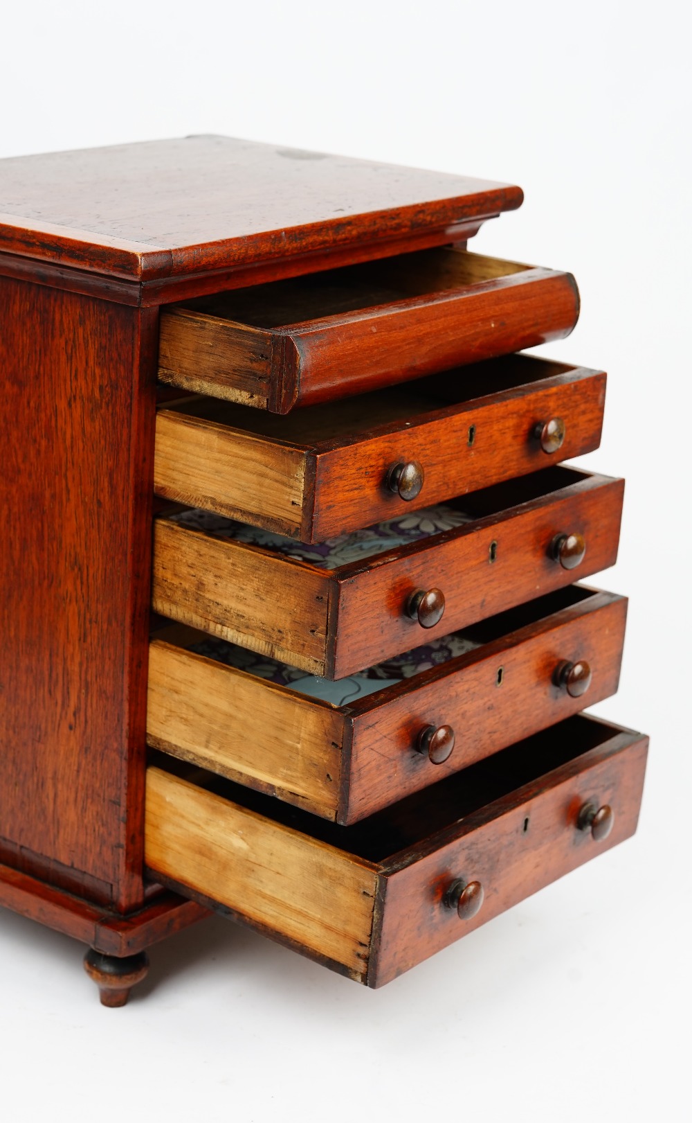 A miniature mahogany chest with a cushion drawer over four long graduated drawers on bun feet, - Image 4 of 5