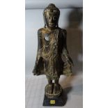 An early 20th century Burmese hardwood figure, 70cm high.
