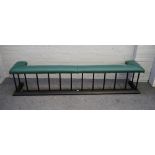 A Victorian style black painted steel and green leather upholstered club fender,