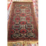 A Belouche rug, the shaped field with four diamonds, a 3-line and leaf border, 145cm x 85cm.