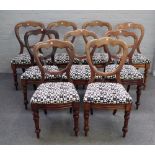 A set of nine Victorian mahogany balloon back dining chairs, on turned supports,