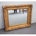 A 19th century rectangular gilt frame with moulded scroll chased decoration and later mirror plate,