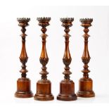 A set of four 20th century carved oak altar sticks, 58cm high.