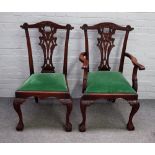 A set of eight 18th century style hardwood Chippendale revival dining chairs on claw and ball feet,
