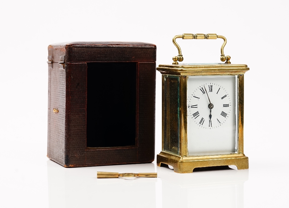 An late 19th century French brass cased carriage clock, with leather travelling case and winder,