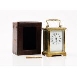 An late 19th century French brass cased carriage clock, with leather travelling case and winder,