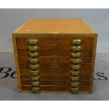 A mid-20th century stained beech collectors chest of nine drawers, 65cm wide x 55cm high.