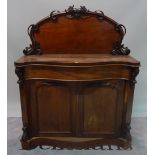 A Victorian mahogany serpentine chiffonier with arch panelled doors, 121cm wide x 148cm high.
