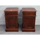 A pair of modern hardwood bedside tables with single drawer over cupboard on shaped plinth base,