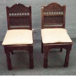 A set of eight Indian hardwood dining chairs with floral trellis carved back on turned supports,