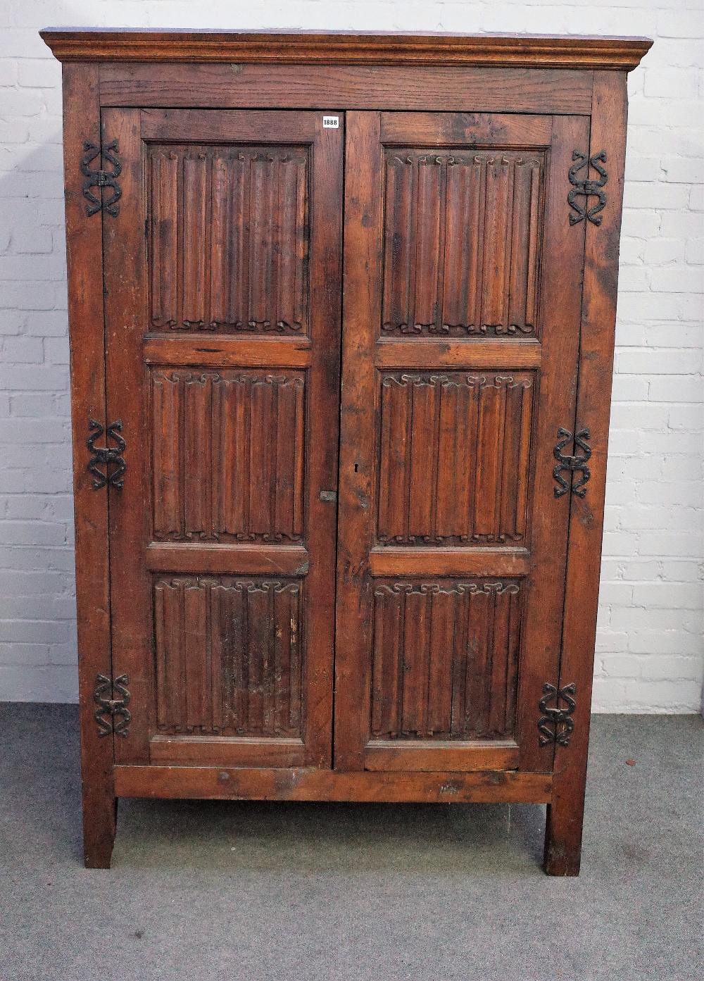 A 17th century style oak hanging cupboard, of panelled construction, incorporating earlier elements,