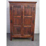 A 17th century style oak hanging cupboard, of panelled construction, incorporating earlier elements,
