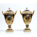 A pair of Berlin porcelain cobalt blue and apricot ground two- handled vases and covers,