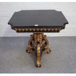A Victorian parcel gilt ebonised centre table with re-entered cornered rectangular top on a trio of