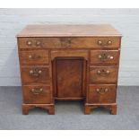 A mid-18th century figured yew kneehole writing desk,
