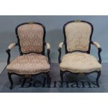 A pair of Louis XV style black painted open armchairs, 59cm wide x 88cm high.