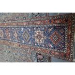 A North Western Persian runner, the indigo field with eleven single medallions,