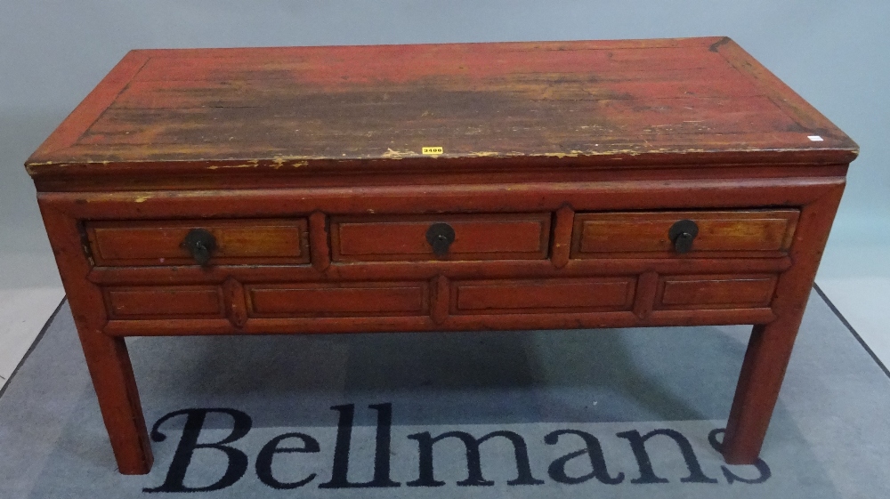 An early 20th century red painted Chinese low side table with three short drawers on block supports, - Image 3 of 3