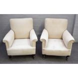 A pair of late 19th century square back easy armchairs with patterned loose upholstery on turned