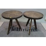 A pair of modern hardwood and metal circular occasional tables, 75cm wide x 73cm high, (2).