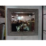 An early 20th century grey painted pine wall mirror with moulded decoration, 83cm x 72cm.