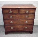 A George III mahogany chest of two short and three long graduated drawers on bracket feet,