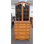 A George III satinwood banded secretaire bookcase chest with a pair of glazed doors over fitted