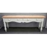 A Victorian pine dresser base/serving table the stripped top over a pair of frieze drawers on