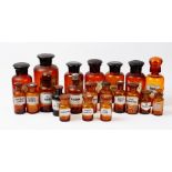 A collection of twenty one 20th century brown and amber glass apothecary jars,