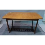 G-Plan, a 20th century teak extending dining table, with shaped supports united by a stretcher,