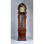 A large Edwardian mahogany three train quarter-chiming Longcase clock The case carved all over