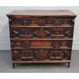 A Charles II oak and fruit wood chest with four long geometric moulded drawers,