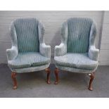 A pair of George I style striped blue upholstered wingback armchairs,