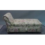 An early 20th century ottoman with roll over arm and floral upholstery, 123cm wide x 69cm high.