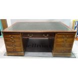 A 19th Century mahogany partner's desk with inset leather top over nine drawers,