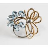 A 9ct gold two colour gold and aquamarine brooch, in an openwork design,