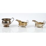 A pair of silver sauce boats each raised on three feet Birmingham 1964 and a sliver sugar bowl