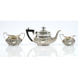 A late Victorian silver three piece tea set, comprising; a teapot having black fittings,