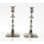A pair of William IV silver table candlesticks, in an 18th century design, each with a shaped stem,
