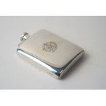 A silver spirit flask of curved rectangular form, monogram engraved, Birmingham 1916,