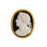 A 19th Century banded agate carved cameo and yellow precious metal mounted brooch of oval design,