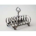 A Victorian silver seven bar toastrack, with a loop shaped handle, raised on four scrolled feet,